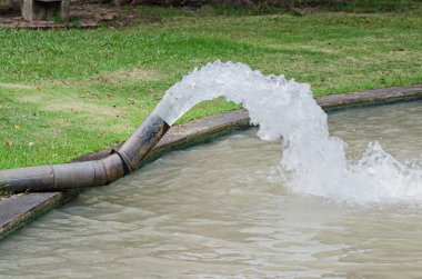Water pouring out from drain water pipe clipart