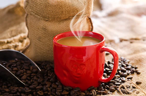 coffee cup with smoke and coffee beans around