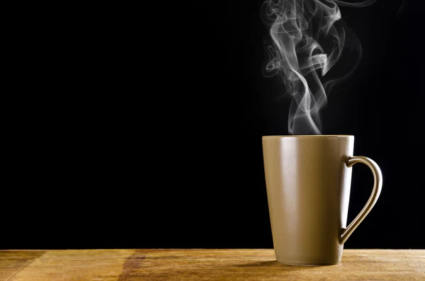 Brown coffee cup with smoke on black background — Stock Photo, Image