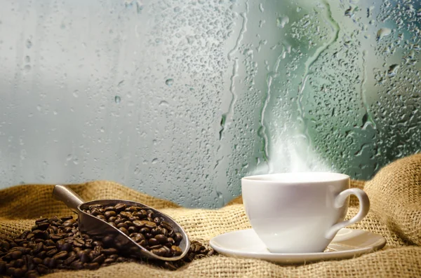 White coffee cup with smoke and bokeh background