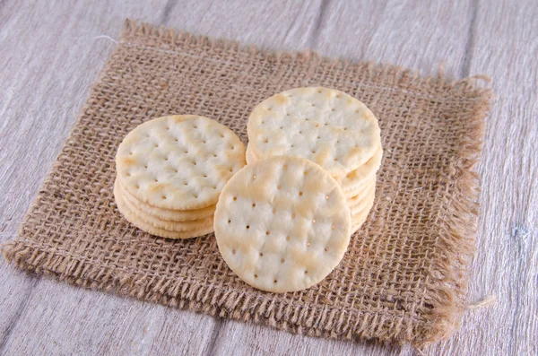 Stack of water cracker on wooden table — Stock Photo, Image