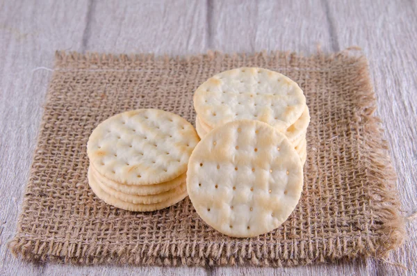 Stack of water cracker on wooden table — Stock Photo, Image