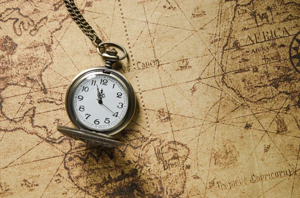 vintage pocket watch on ancient map background