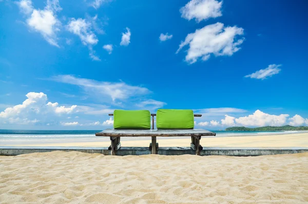 Grüne Sitzbank oder Holzbank mit Meerblick und bewölktem Himmel — Stockfoto