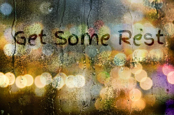 Natural water drops on glass window with word "Get Some Rest" — Stock Photo, Image