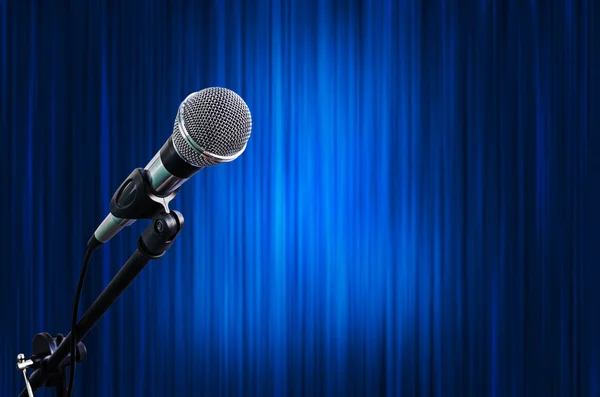 Microphone on Blue Curtain Stage Background with light spots — Stock Photo, Image