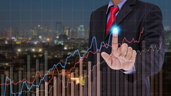 Business man touch visual graph on screen with night city backgr — Stock Photo, Image