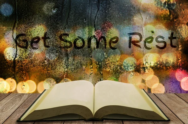 Open book with water drop on glass window "Get Some Rest" — Stock Photo, Image