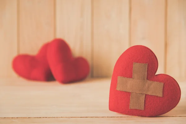 Wound heart with couple red heart background — Stock Photo, Image
