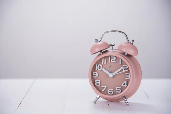 Alarm clock on wooden table with copy space — Stock Photo, Image