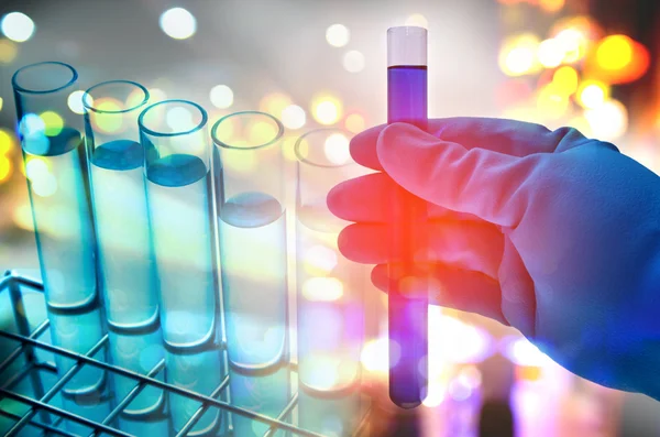 Double exposure of scientist hand holding laboratory test tube — Stock Photo, Image