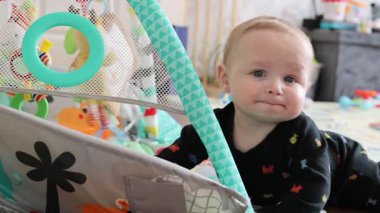 Bebek Yaşam Odası 'nda Merakla Uzanıyor ve Keşfediyor. Genç Çocuk, canlı yaşam ortamında aktif erişimle ve oyuncu etkileşimle erken merakını gösteriyor