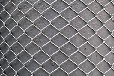 metal grid pattern and texture background, abstract industrial metallic surface, shiny aluminum mesh on grey textured iron pole, steel wire security fence, isolated outdoors, grunge backdrop