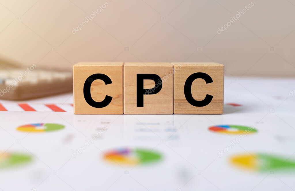 CPC word built with wooden cubes and black letters on grey background. cost per click in digital marketing.