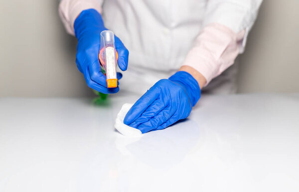 Cleaning table with disinfectant spray and Microfiber close up for covid preventing.