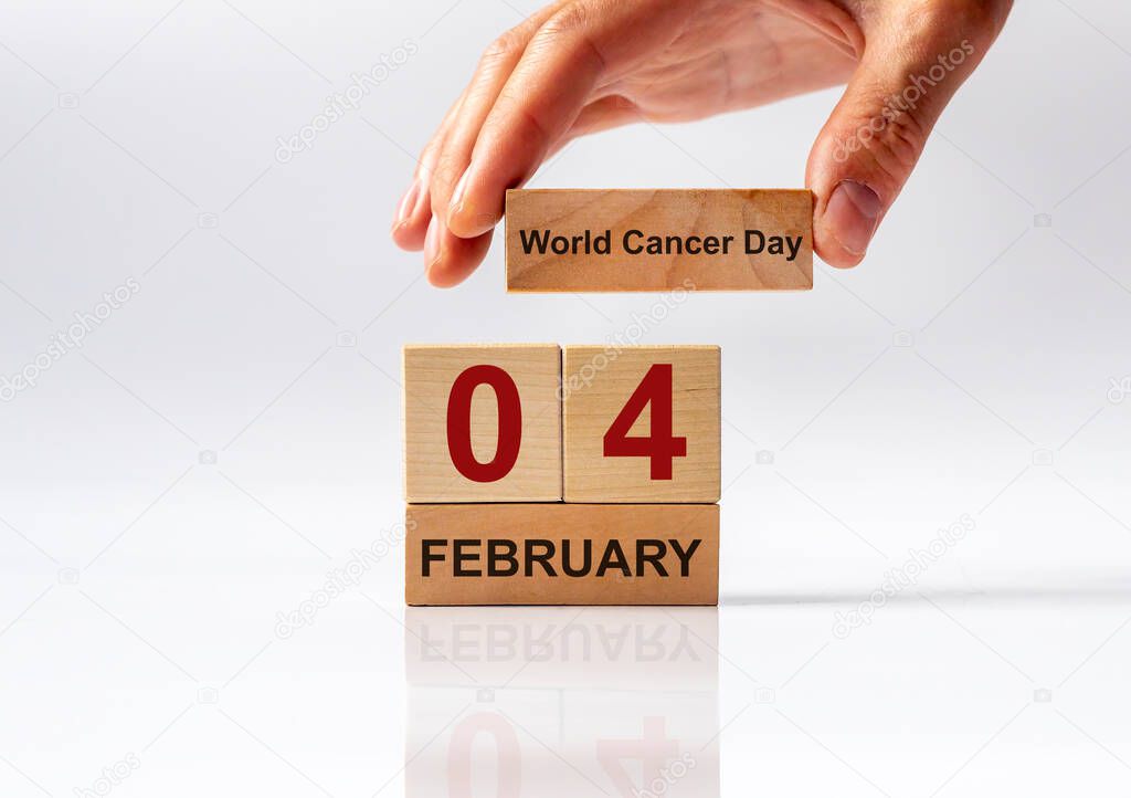 4 February date. International or World Cancer Day on wooden calendar.