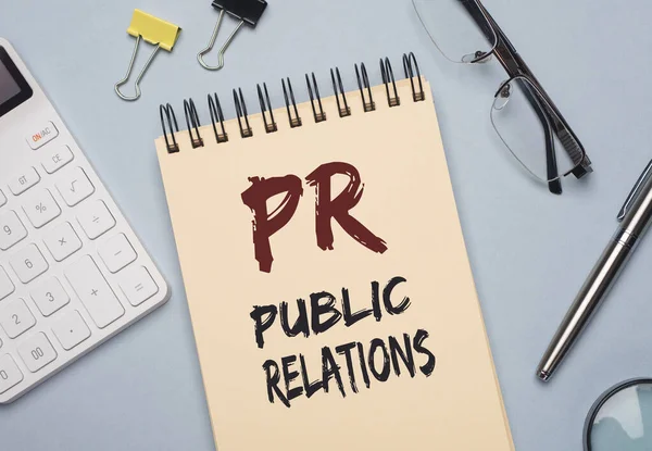 PR acronym word on paper. Public Relations concept.