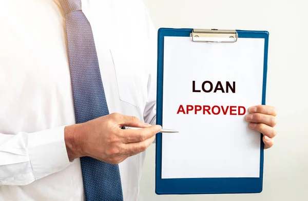 Loan approved inscription on paper. Financial borrowing and lending concept.
