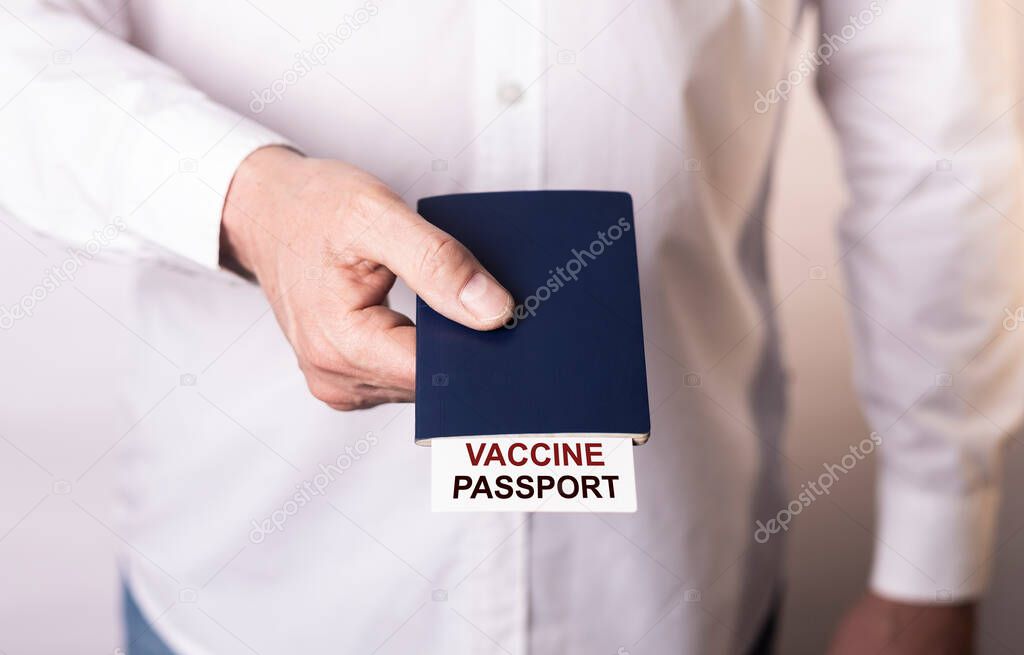 Male hand giving vaccine passport towards.