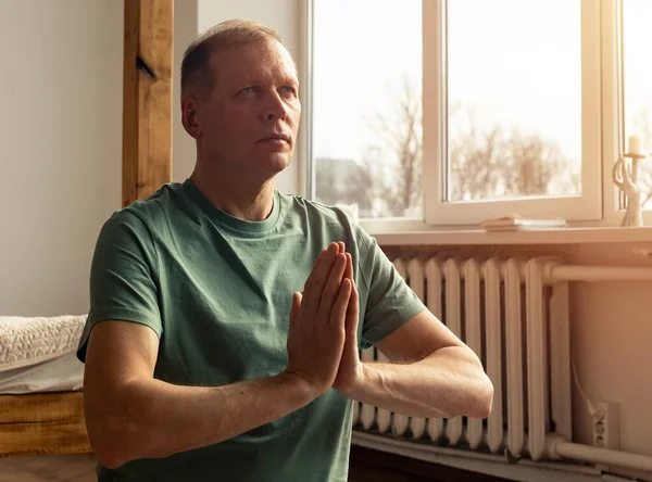 Reifer Mann Praktiziert Yoga Und Meditiert Hause Mit Zusammengehaltenen Händen — Stockfoto