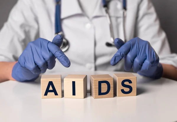 AIDS acronym word inscription in doctor hands — Stock Photo, Image
