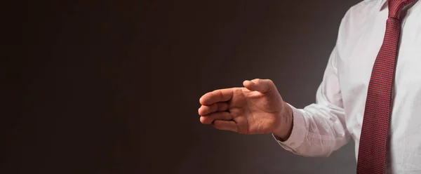 Businessman outsretched his hand for handshake over black background. Cropped man in white shirt and tie. Banner with copy space for text — Stock Photo, Image