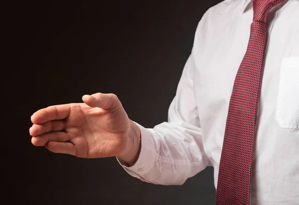 Businessman outsretched his hand for handshake over black background. Cropped man in white shirt and tie, close up — Stock Photo, Image