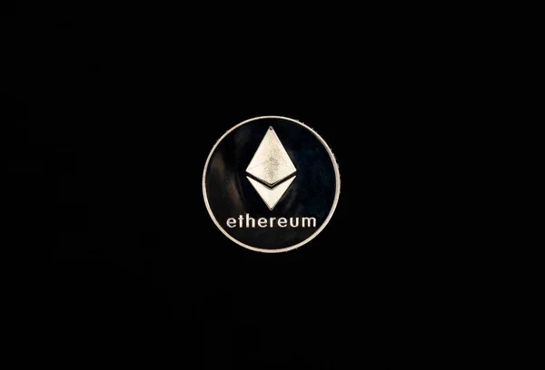 Ethereum or etherum silver coin on black background. Top view of eth symbol — Stock Photo, Image