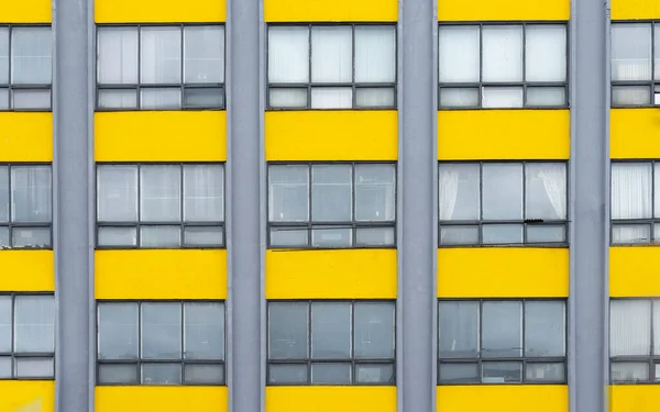 Yellow and gray building background with windows. Architecture exterior — Stock Photo, Image