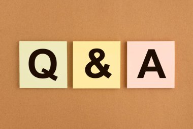 QA acronym on sticky notes on brown board. QnA word. Q concept. Questions and answers