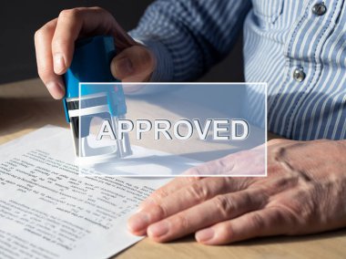 Word approved on image with hands verifying and stamping document, contract