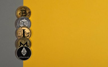 Various shiny crypto currency coins, cryptocurrency. Bitcoin, litecoin, eth, monero and NEO on yellow and gray background. Banner with copy space for text
