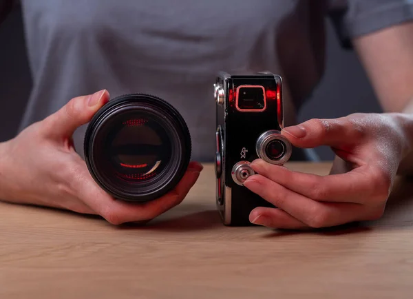 Photographer showing two cameras, vintage old one and modern digital lens, closeup — Stock fotografie