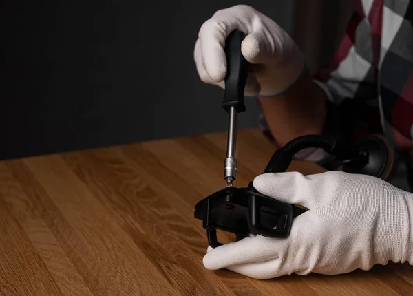 Fixing with screw driver. Screwdriver tool in hands in gloves — Stockfoto