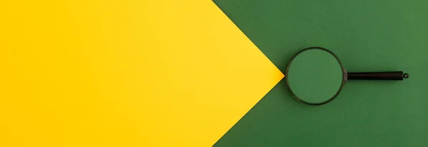 Bright banner of green and yellow colors with magnifying glass. Background with copy space