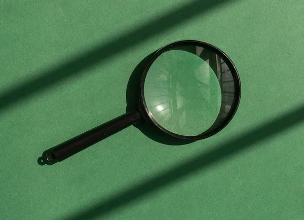 Magnifying glass over eco green background with sunny light. Magnifier as concept of QnA — Stock Photo, Image