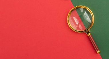 Magnifier on red background with copy space for text