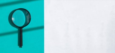 Magnifying lens over white banner with light blue stripe. Search tool concept. Background with copy space