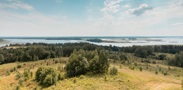 Summer nature landscape with sky, forest trees and water lakes. High angle view of natural rural scenery