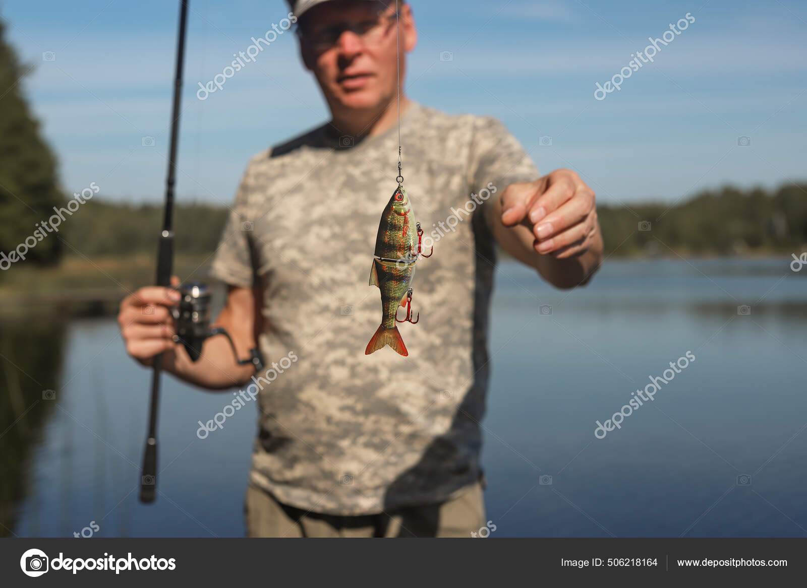 Swim bait or wobbler on fishing rod for predator fish catching and