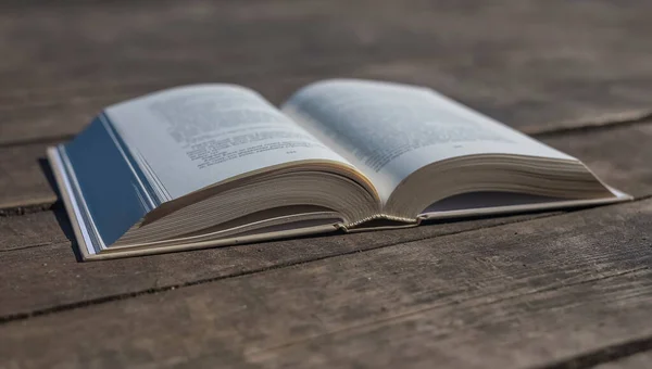 Öppna modern bok på gammalt skrivbord med dagsljus. Begreppet kunskap — Stockfoto