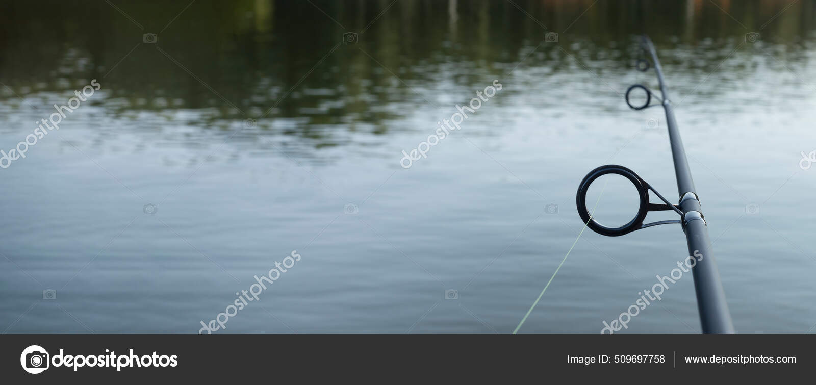 Fishing rod over freshwater with copy space. Banner Stock Photo by  ©val.suprunovich 509697758