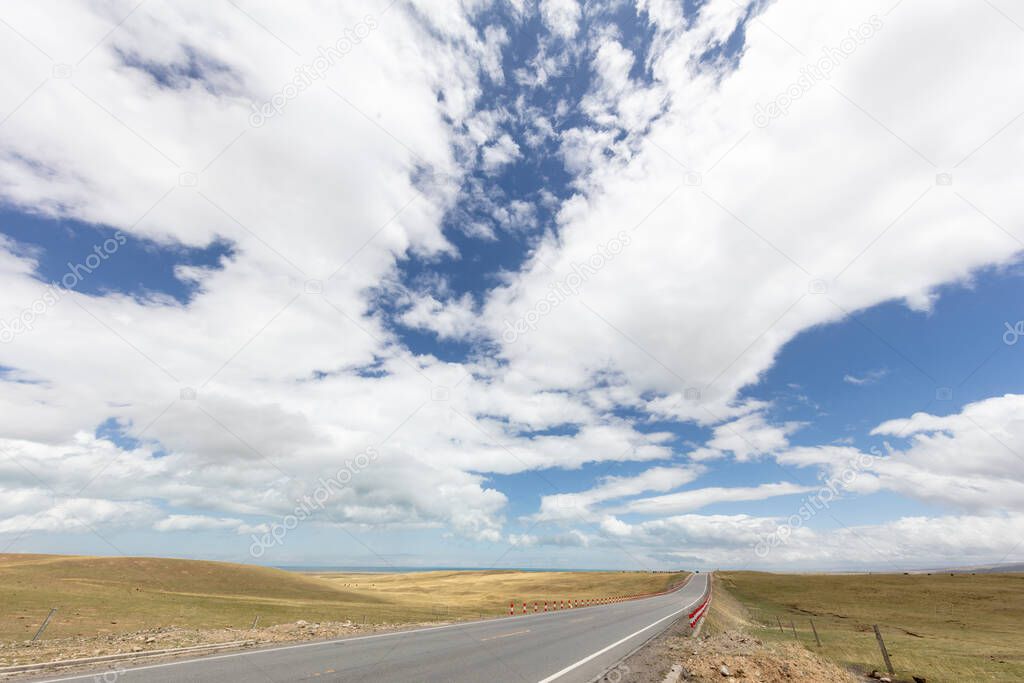 Mountains and grasslands stretch by road in Qinghai province, China
