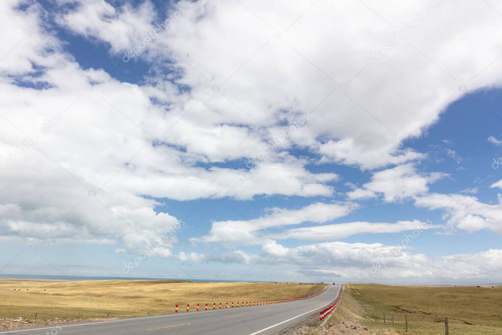 Mountains and grasslands stretch by road in Qinghai province, China