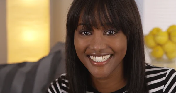 Pretty black woman smiling in striped shirt — Stock Photo, Image