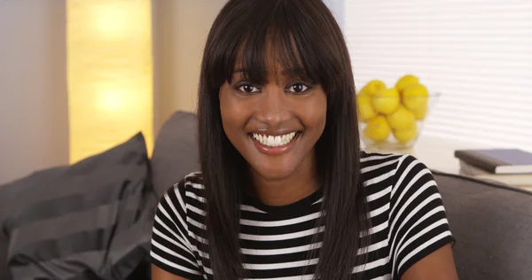 Pretty black woman smiling in striped shirt — Stock Photo, Image