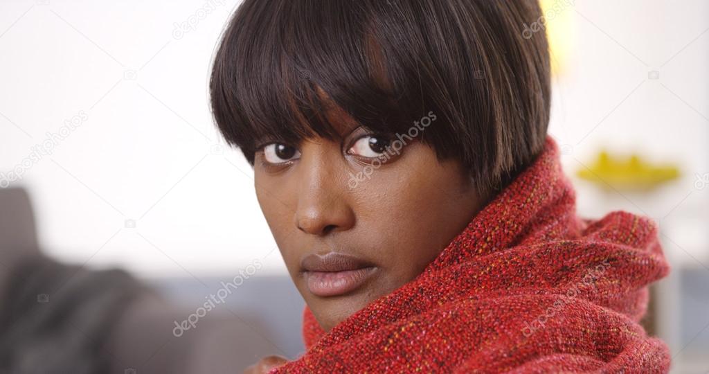 Sultry black woman wearing red shawl