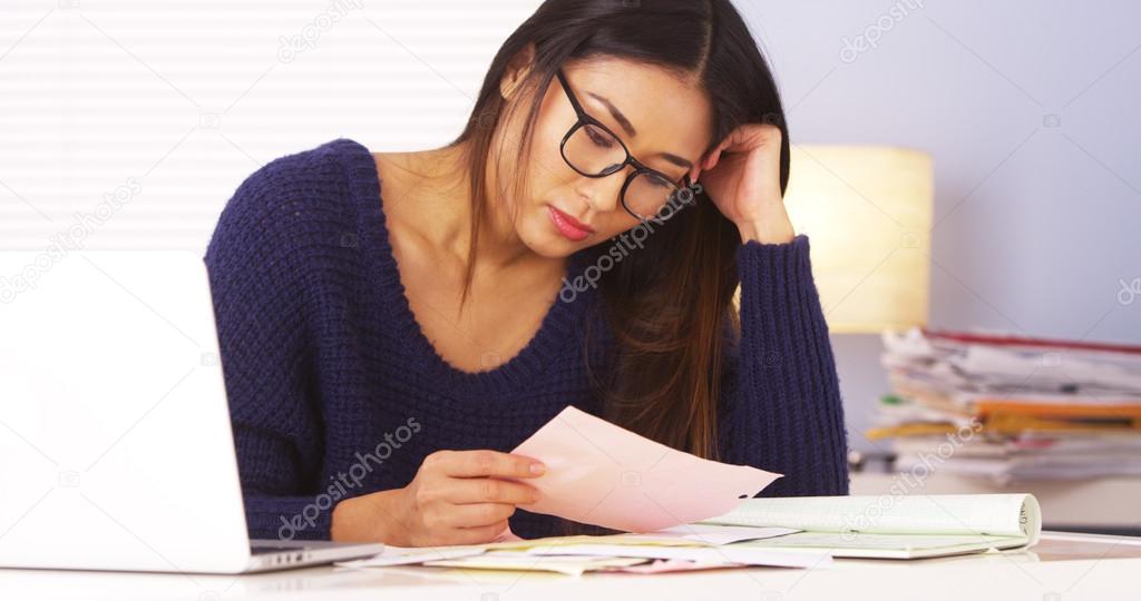 Japanese woman looking over bills