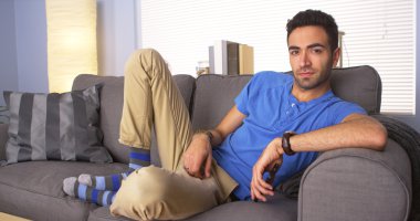 Mexican guy chilling on couch clipart