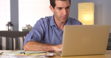 Man using laptop for online banking clipart